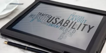 A tablet sitting on top of a table next to a cup of coffee displaying different aspects of accessibility testing