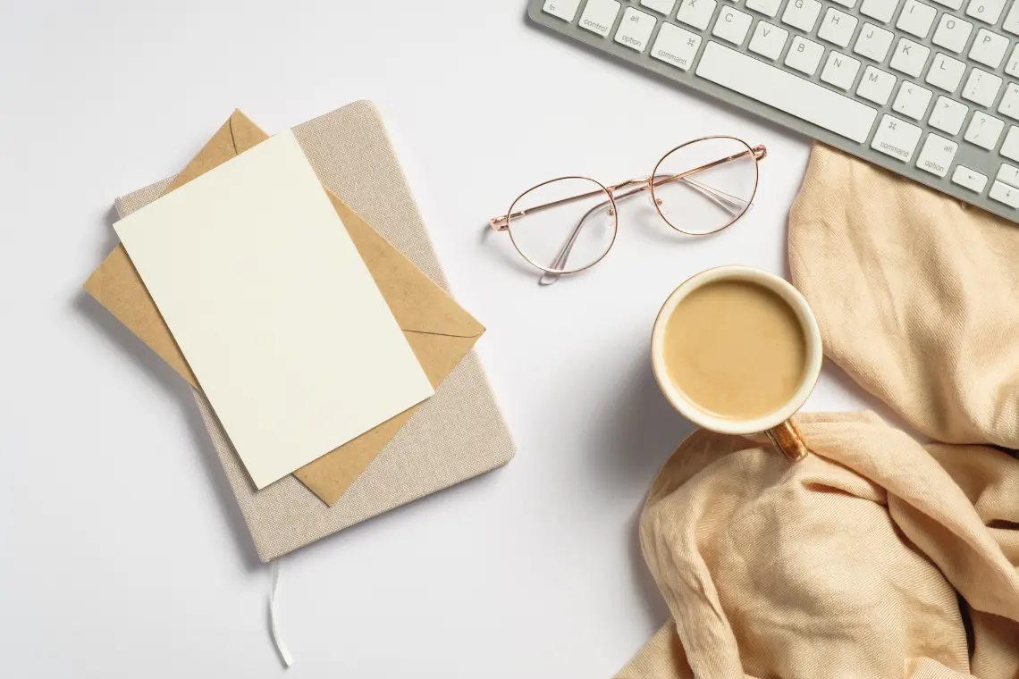 Minimalist work desk setup with coffee and glasses