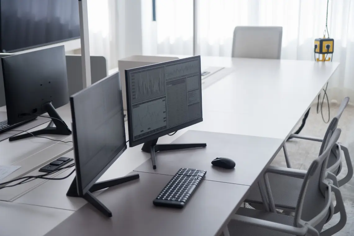 Professional workspace with multiple monitors best computer table setup displaying data charts