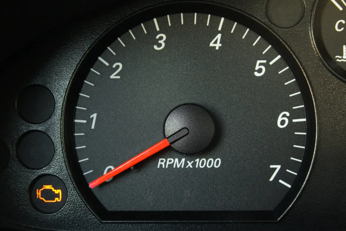 Check engine warning light on a vehicle's dashboard symbolizing the importance of debugging skills for JavaScript interview preparation