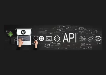 Hands typing on a laptop with API development icons, showcasing technology and integration