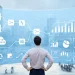 A professional analyzing data flow and database performance charts with technical visual elements