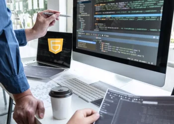 Developers working with JavaScript code on multiple screens