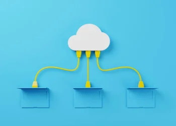 Cloud data management concept with laptops connected to a cloud via network cables.
