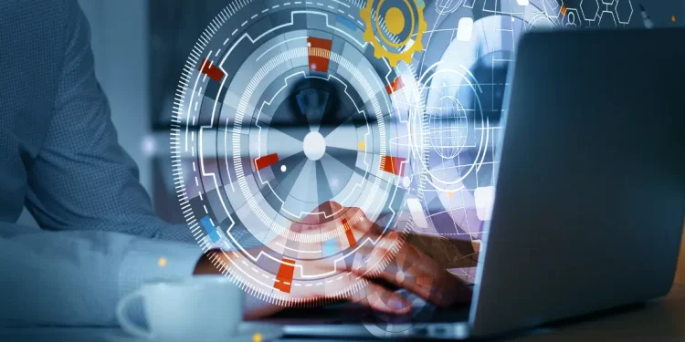 Person working on laptop with digital transformation interface graphics, representing accountability and collaboration.